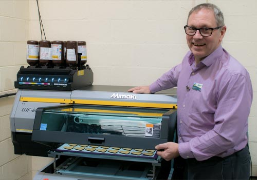 Ian Bradbeer from Badgemaster with a Mimaki UJF 6042 Mk II e digital printer from CMYUK.