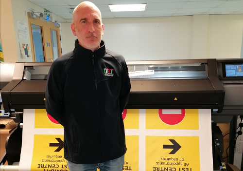 Aaron Hartley, Print and Mail Manager at Delt Shared Services with a HP L560 Latex printer