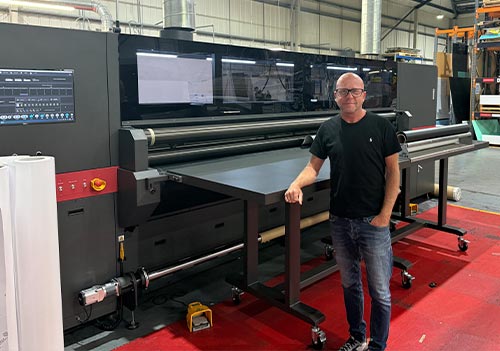 Simon McKenzie, CEO, Hollywood Monster with his 14th EFI VUTEK printer.