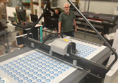 Neil Faudemer and Dave Wood from Mailmate with a Kongsberg X24 Edge digital cutting table from CMYUK
